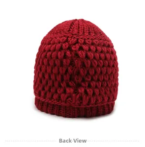 Back view of thick red winter knit hat for elderly women showing warm textured wool fabric