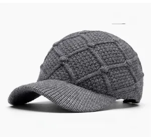 Close-up of grey knit baseball cap featuring thick textured diamond pattern and ribbed brim