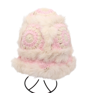 Detailed close-up of pink and white hand-crocheted plush hat with fluffy faux fur trim