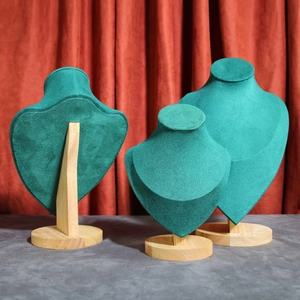 Three green velvet necklace display stands with solid wood bases in various sizes