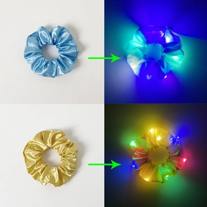 LED scrunchies in blue and yellow showing light-up effects in bright and dark environments