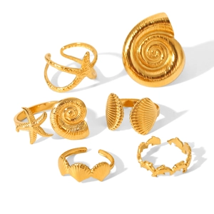 Detail view of 6-piece gold ocean jewelry set with starfish, seashell, and dolphin rings