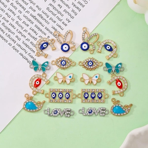 Flat lay of alloy jewelry charms with crystals in evil eye and animal shapes