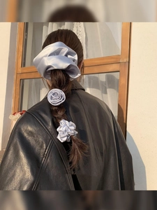 Detailed back view of grey silk scrunchie set including rose flower and pleated styles