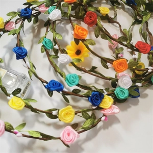 Close-up of colorful artificial rose floral headbands with satin ribbons and green leaves