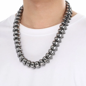 Punk skull beaded necklace for men in dark silver steel worn by a male model