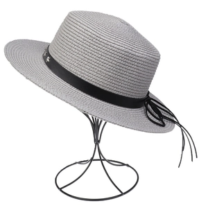 Close-up of light gray straw hat with black leather star rivet band and bow detailing