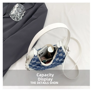 Top view of blue denim checkered mini bag showing interior capacity and white strap details