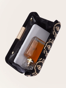 Interior view of black velvet evening clutch showing space for phone and perfume bottle