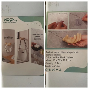 Detailed retail packaging for hand shape wall hook including installation guide and resin specs