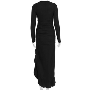 Detail of ribbed knit fabric texture and side ruffle design on a slim black dress