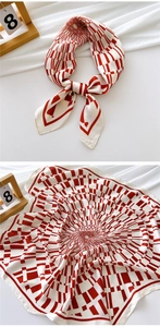 Detail of red and white geometric silk scarf with smooth texture and radiant pattern