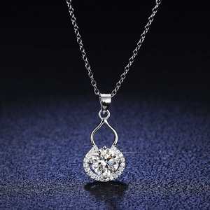 Silver gourd necklace with large central crystal and diamond accents on dark background