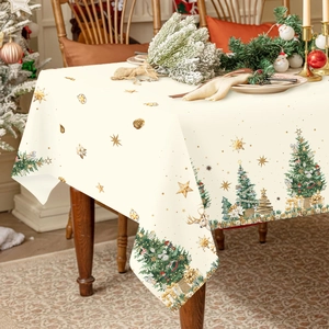 Waterproof Christmas tablecloth featuring reindeer and trees on a wooden dining table