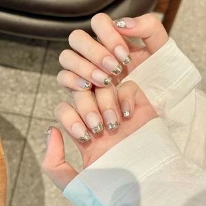 Pink cat eye press-on nails with silver metallic French wave edges in a minimalist style