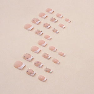 Short ballet press-on nails with white French tips and colorful rhinestones
