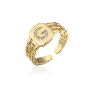 Detailed macro of gold adjustable open ring featuring micro-pave zircon letter G design