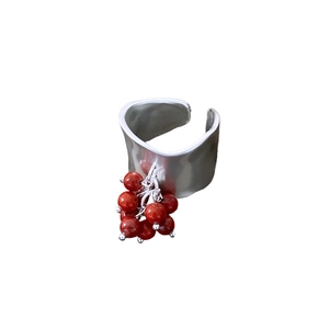 Irregular textured silver wide band ring with a cluster of red bead pendants for women