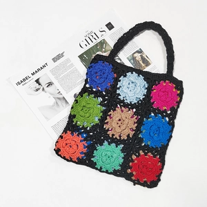 Detailed view of handmade crochet tote bag with colorful floral granny square patterns