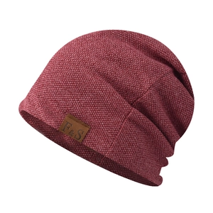 Close-up of burgundy knit beanie featuring detailed texture and F&S leather brand patch