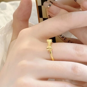 Exquisite gold bowknot ring in titanium steel with a minimalist thin band design