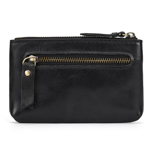 Detailed macro of black genuine leather coin purse with three zippers and brass hardware