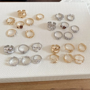 Macro shot of gold and silver textured resin rings set with rhinestone accents