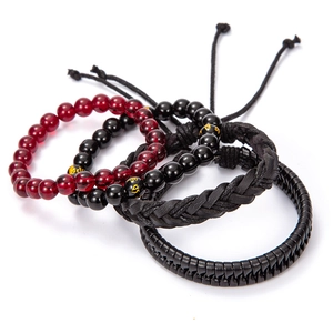 Detail of four-piece retro set with black and red beads, braided leather and cord cords