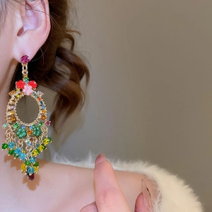 Detail of colorful crystal tassel flower earrings showing vibrant rhinestones and gold plating