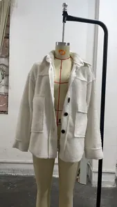 Close-up of white fleece shirt jacket with black buttons and large chest pockets