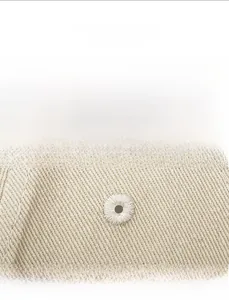 Close-up of embroidered breathable eyelets on beige cotton twill baseball cap fabric