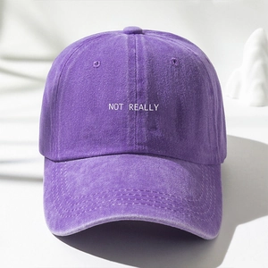 Detail showing the purple washed Y2K baseball cap with NOT REALLY white embroidery