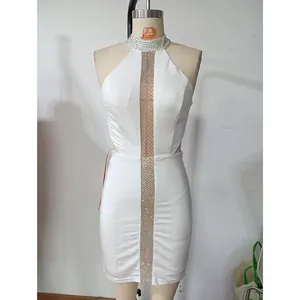 Detail of white bodycon dress with rhinestone halter neck and mesh cutout panels