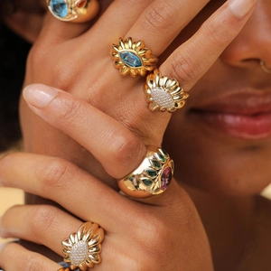 Detailed view of gold stainless steel rings with colorful zircon floral patterns