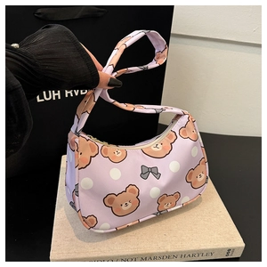 Detail of purple bear pattern shoulder bag with white polka dots and secure zipper closure