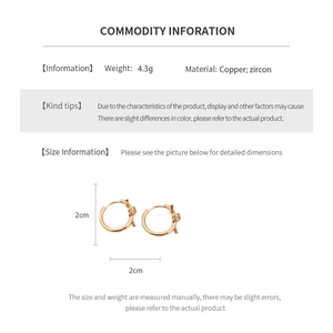 Macro detail of 18k rose gold plated hoop earrings with zircon and rope texture