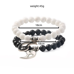 Detail view of black and white beaded bracelets showing the yin yang pendant and 18cm size