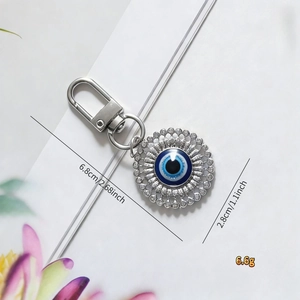 Detail showing the 2.8cm blue evil eye pendant with silver keyring and dimensions