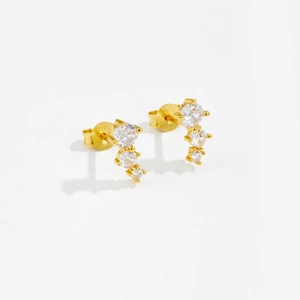 Detail view of 925 sterling silver stamp on golden geometric stud earrings with zircons