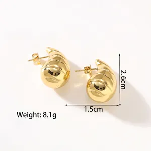 Detailed view of gold croissant earrings with dimensions 2.6cm by 1.5cm and spiral texture