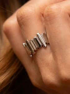 Macro shot of silver-toned irregular vertical bar ring with a polished geometric finish