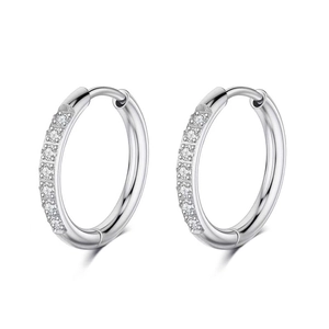 Macro shot of silver stainless steel huggie earrings with sparkling pavé cubic zirconia