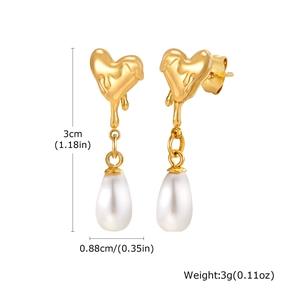 Detail view of 18K gold heart-shaped fluid metal earrings with white drop pearl drops