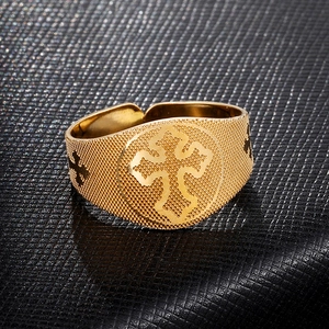 Detailed macro view of 18K gold cross ring with fine mesh texture on black leather