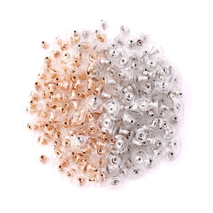Golden and silver bullet earring backs with clear plastic pads on white background