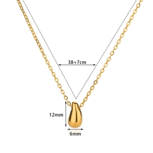 Detail view of gold teardrop pendant with dimensions 12mm by 6mm and 38cm chain