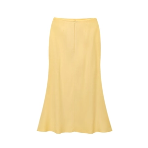 Detail of light yellow maxi mermaid skirt with slim fit cut and refined fabric texture