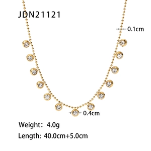Detailed view of gold stainless steel necklace with sparkling round zircon pendants