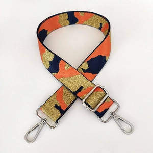 Detail of adjustable wide camouflage strap with orange navy weave and silver hooks