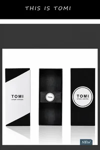 Detailed view of minimalist TOMI watch packaging box with black and white branding